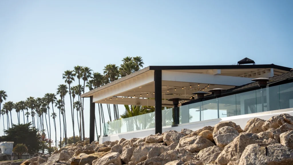 The Ellwood pavilion and palm row seen from Goleta Beach, ten minutes from Santa Barbara Airport